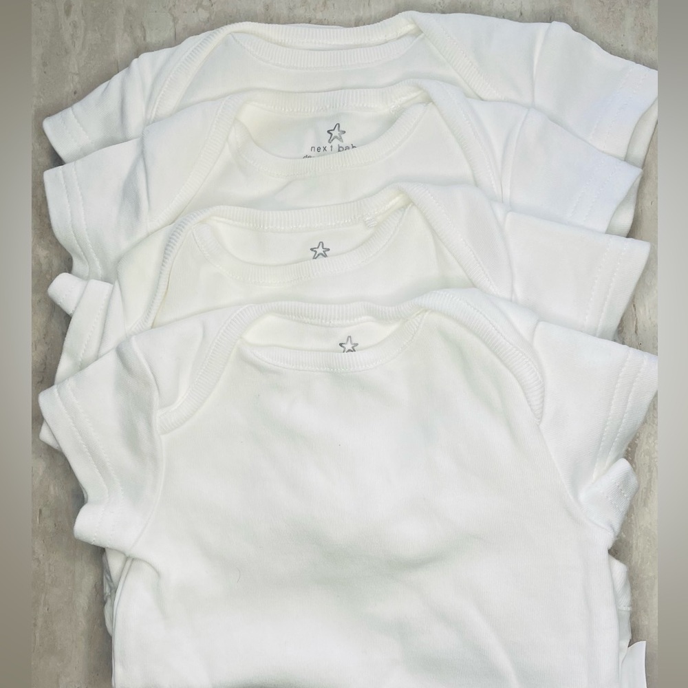 4 pack essential white tee bodysuits. 0-3 M